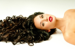 brunette with curly hair and red lipstiks